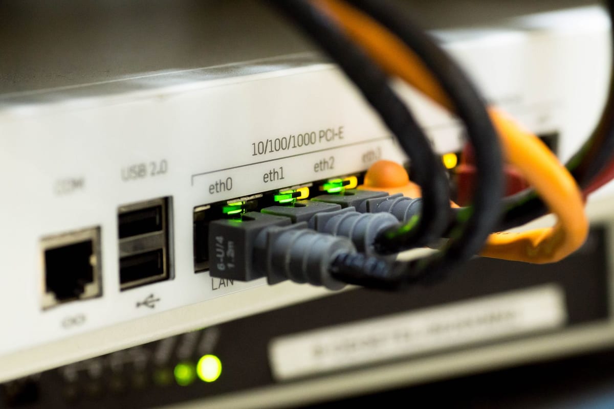 Patch cords plugged into the ports of a network router