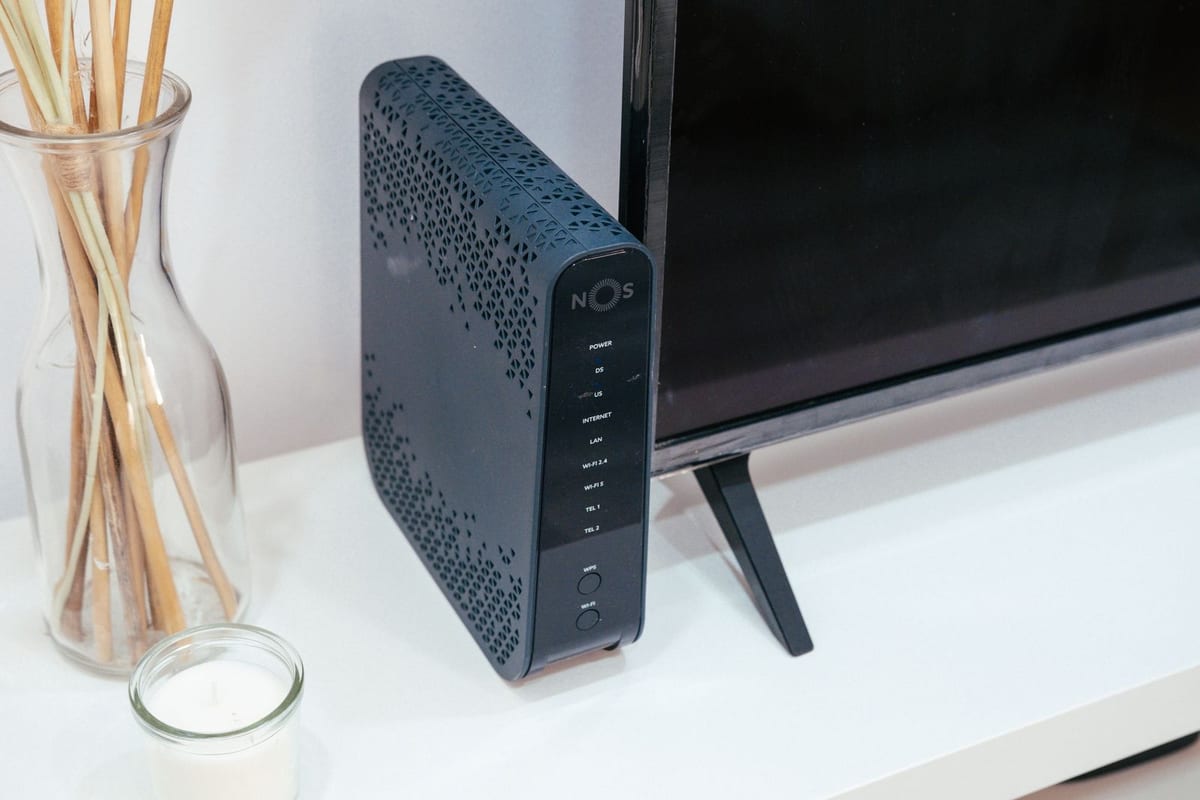 A home router next to a television in a living room